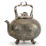 Good Indian white metal teapot with serpent handles and knop finely engraved with deities amongst