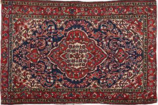 Rectangular Persian blue and red ground rug having and allover floral design, 146cm x 103cm : For