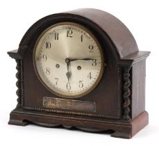 Oak cased mantle clock with silvered dial having Arabic numerals and silver presentation plaque