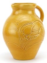 Early 20th century Susie Cooper green glazed jug incised with two stylised leaping deer, 22cm high :