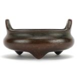 Chinese patinated bronze tripod censer with twin handles, character marks to the base, 8cm in
