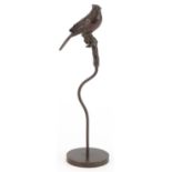 Patinated bronze sculpture of a bird perched on a branch, 17cm high : For further information on