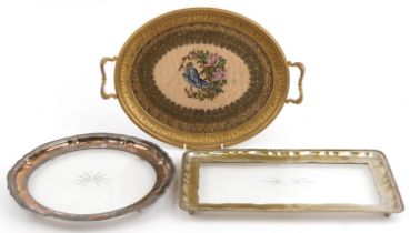Three metal and glass trays comprising a good quality French style gilt brass twin handled example
