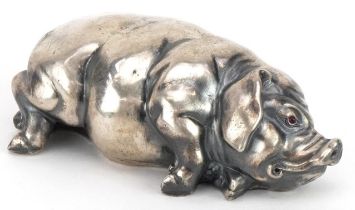 Silver recumbent pig with cabochon ruby eyes, impressed Russian marks to the base, 7cm in length,