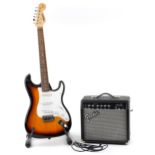 Starcaster by Fender six string electric guitar with Fender Front Man 15G amplifier and stand, the