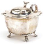 Edwardian silver four footed mustard with blue glass liner, indistinct maker's mark Birmingham 1909,