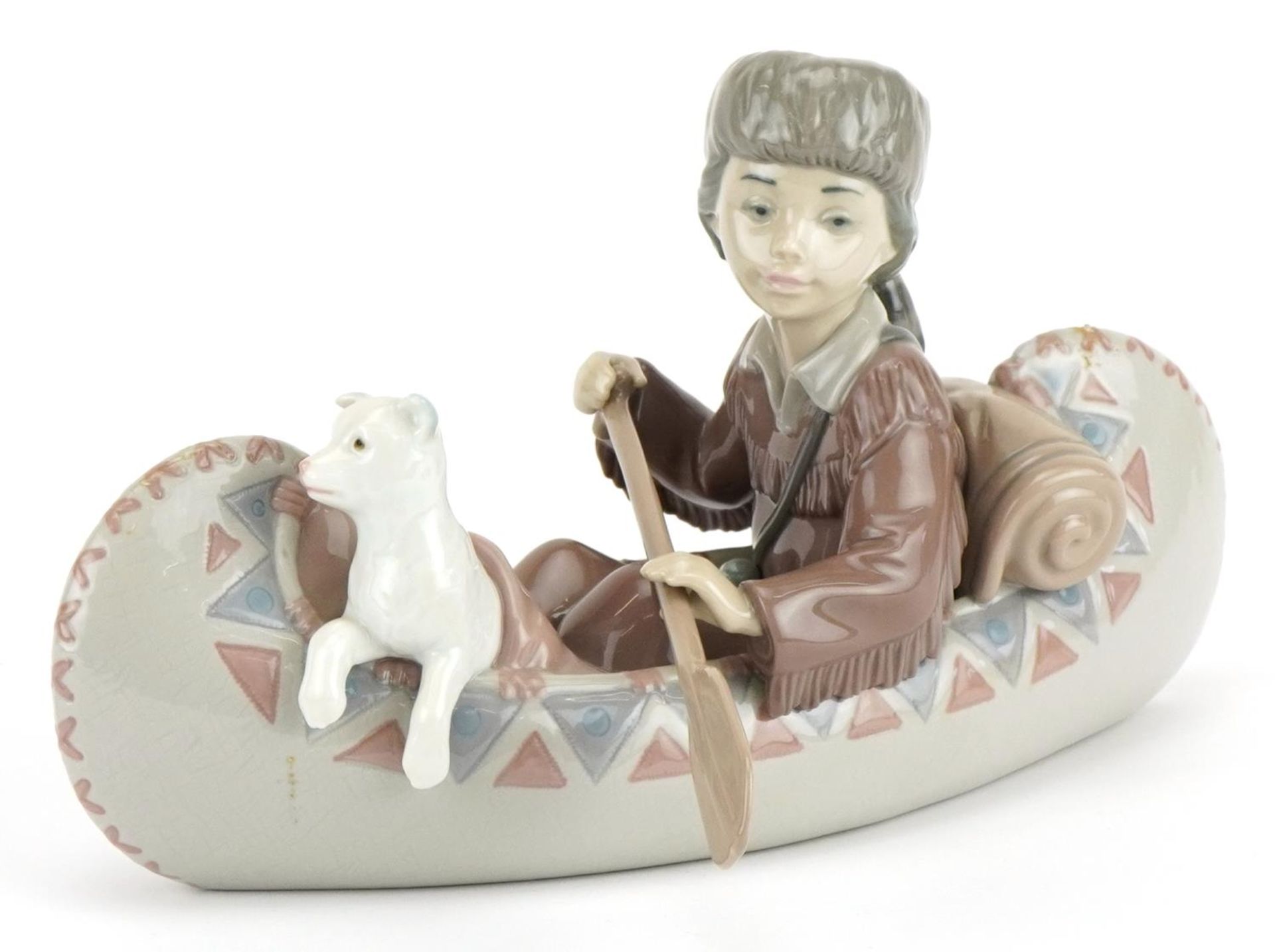 Lladro figure group of a boy with dog in a canoe, Little Explorer, numbered 6640, 25cm in length :