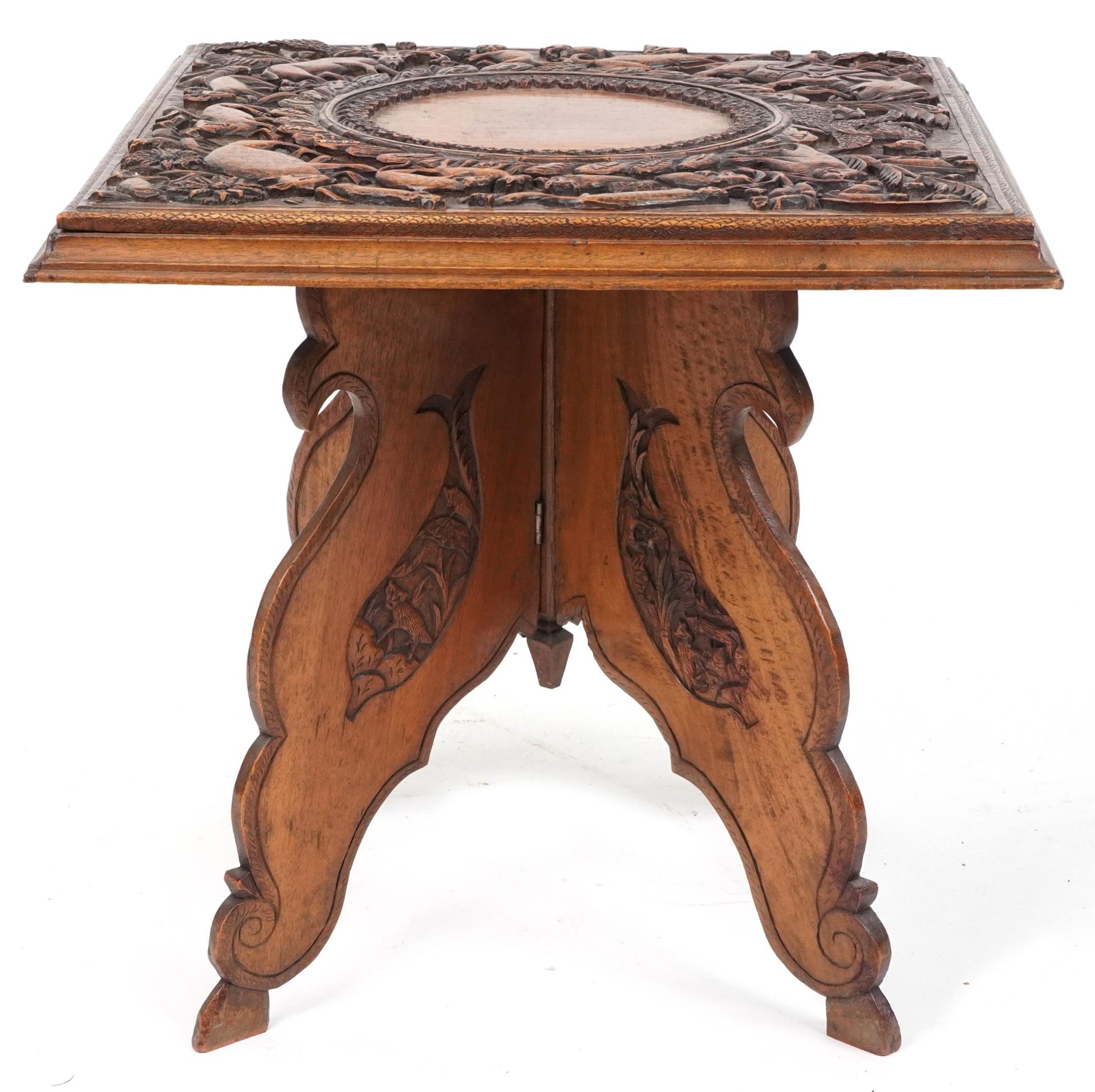 Anglo Indian hardwood folding side table, finely and deeply carved with an elephant and wild animals - Image 4 of 4