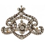 Antique unmarked yellow and white gold Belle Epoque diamond brooch pendant of scroll design with