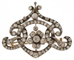 Antique unmarked yellow and white gold Belle Epoque diamond brooch pendant of scroll design with