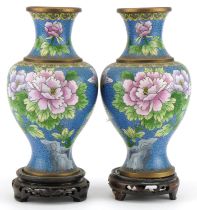 Pair of Chinese Jingfa cloisonne baluster vases raised on hardwood stands enamelled with flowers,