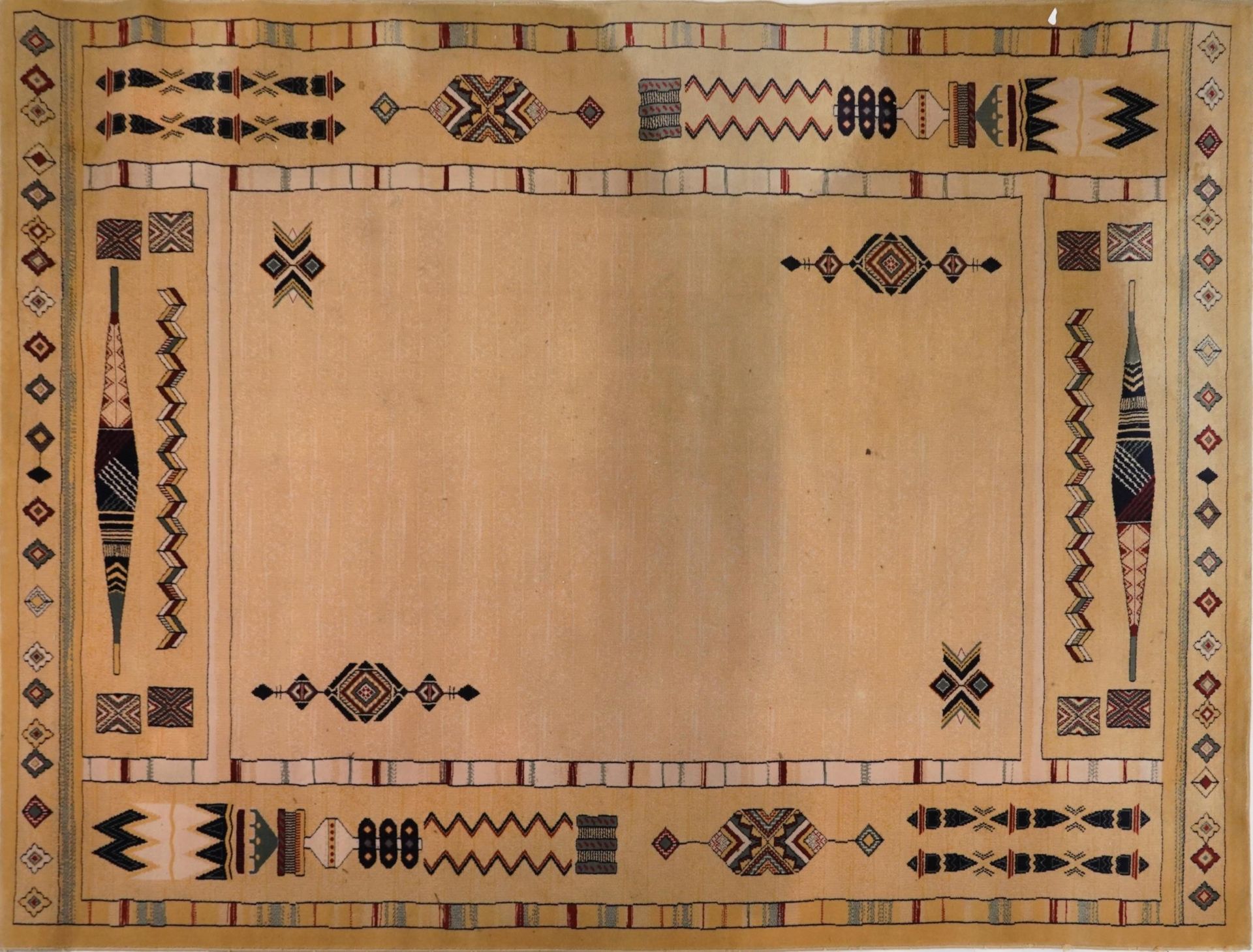 Rectangular Aztec style beige ground rug having and allover repeat design, 300cm x 202cm : For