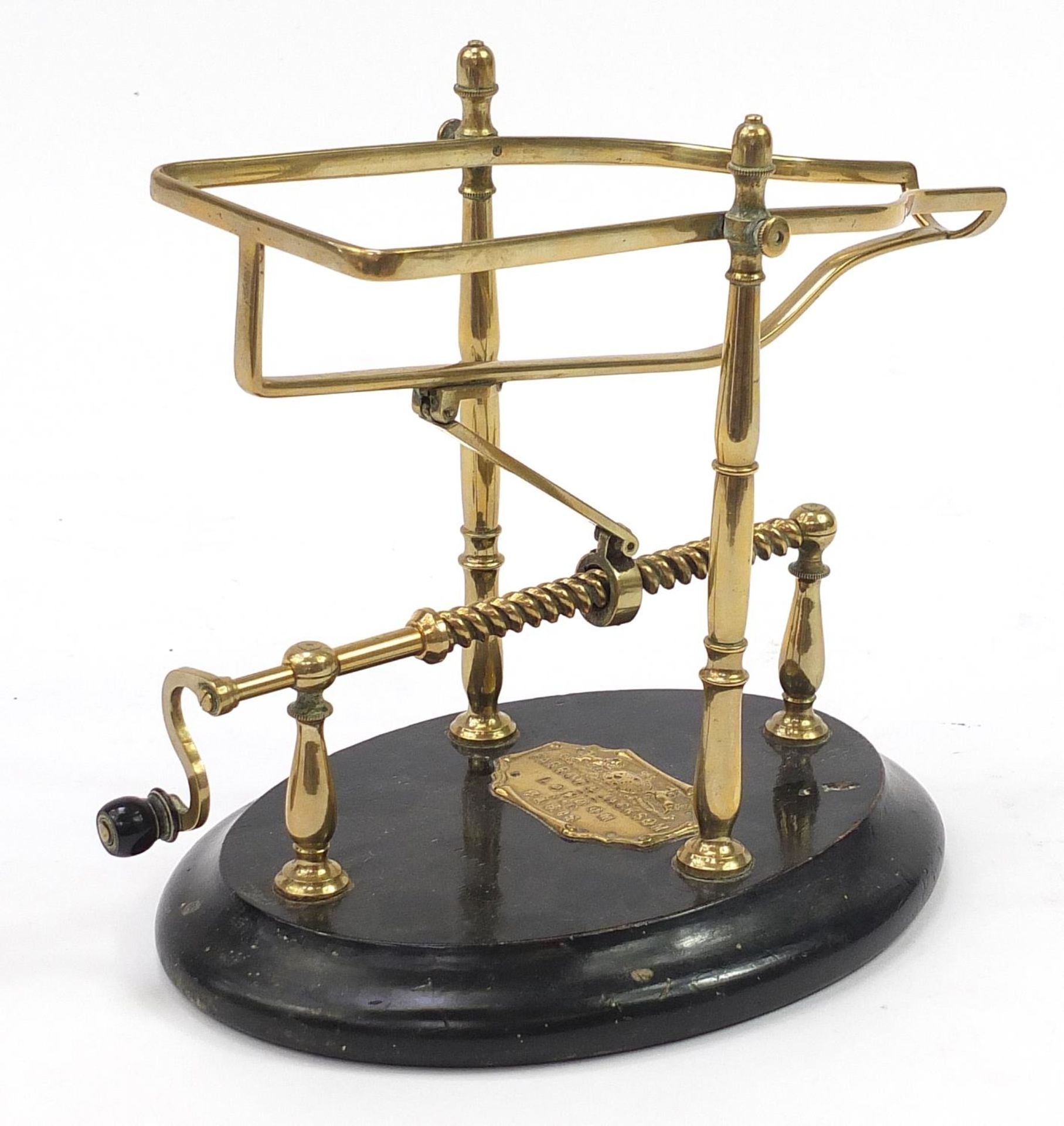 Farrow & Jackson of London & Paris, 19th century brass mechanical wine cradle with an ebonised base, - Image 2 of 4