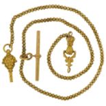 Antique unmarked gold and yellow metal ball link watch chain with hand design clasp and T bar, the