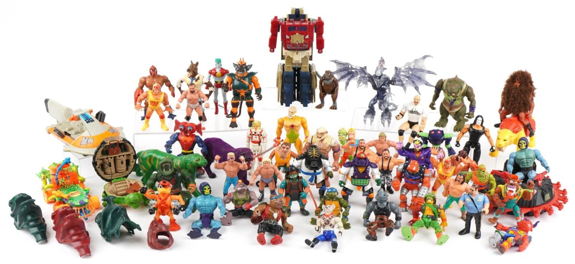 Collection of vintage and later toys, predominantly action figures, including World Wrestling