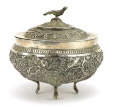 Chinese export unmarked silver four footed bowl and cover profusely embossed with birds amongst