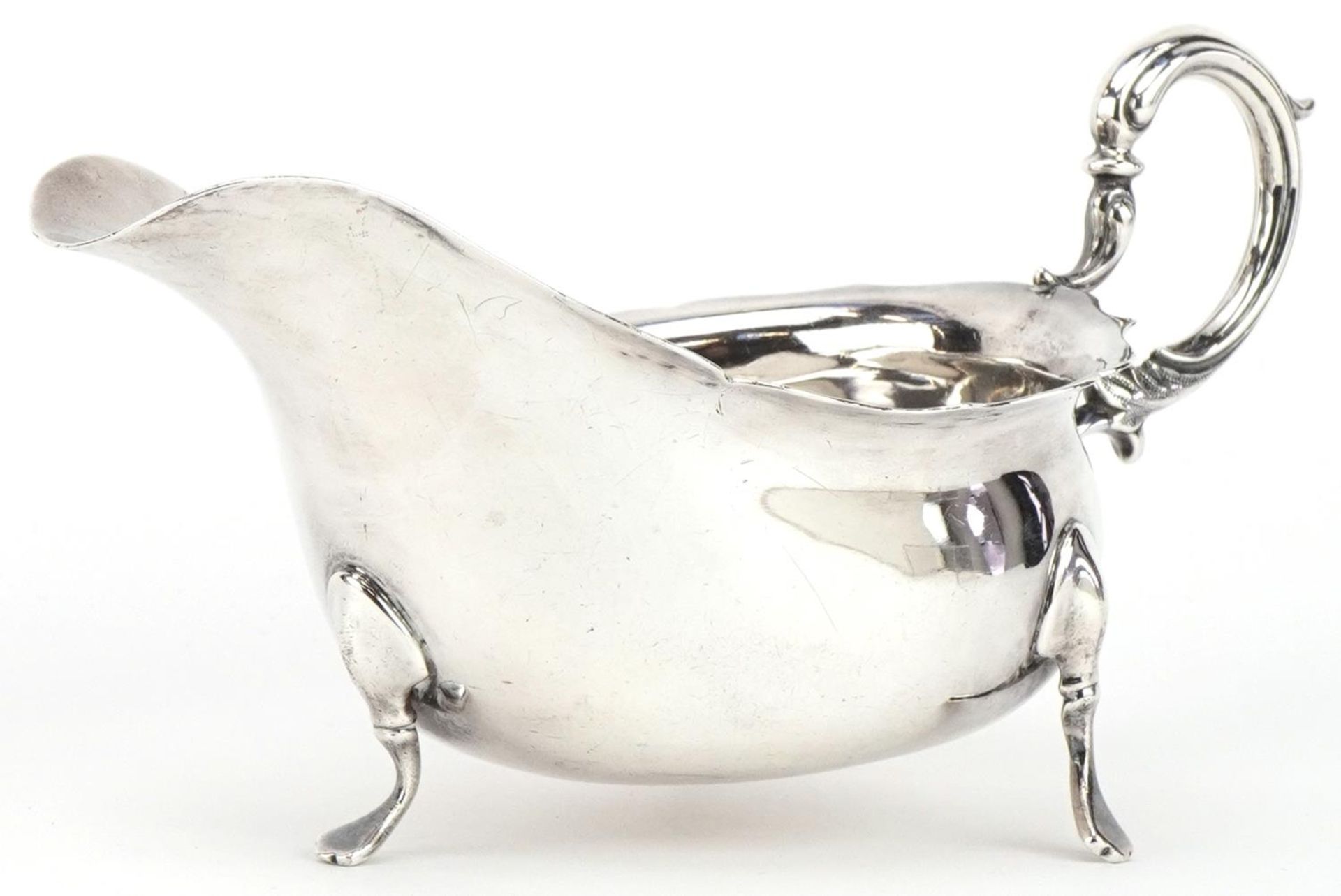 William Hutton & Sons Ltd, George V silver three footed sauceboat, Birmingham 1919, 19.5cm wide,