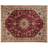 Rectangular Indian Rani rug having an allover repeat floral design on the red and cream grounds,
