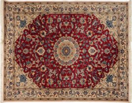 Rectangular Indian Rani rug having an allover repeat floral design on the red and cream grounds,