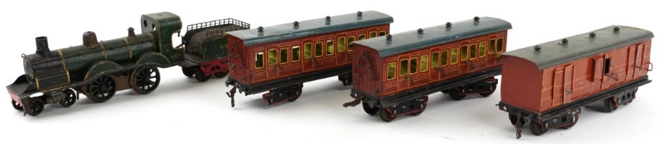 German tinplate O gauge railway GNR locomotive with tender and three first class carriages, the