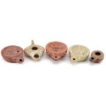 Five Roman style terracotta and pottery oil lamps, the largest 11.5cm in length : For further