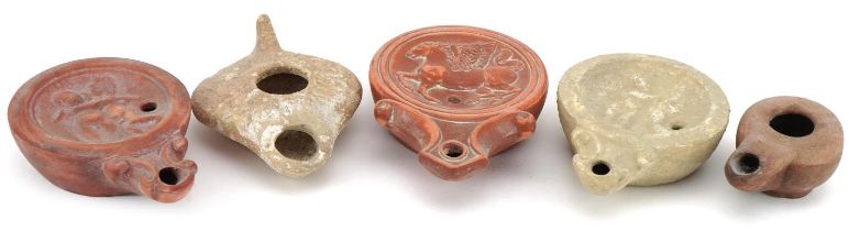 Five Roman style terracotta and pottery oil lamps, the largest 11.5cm in length : For further