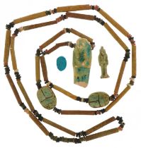 Ancient Egyptian artifacts including faience bead necklace with shabti and scarab beetles and an