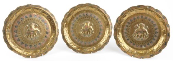 Three Indian silver, copper and brass trays embossed with elephants and wild animals : For further