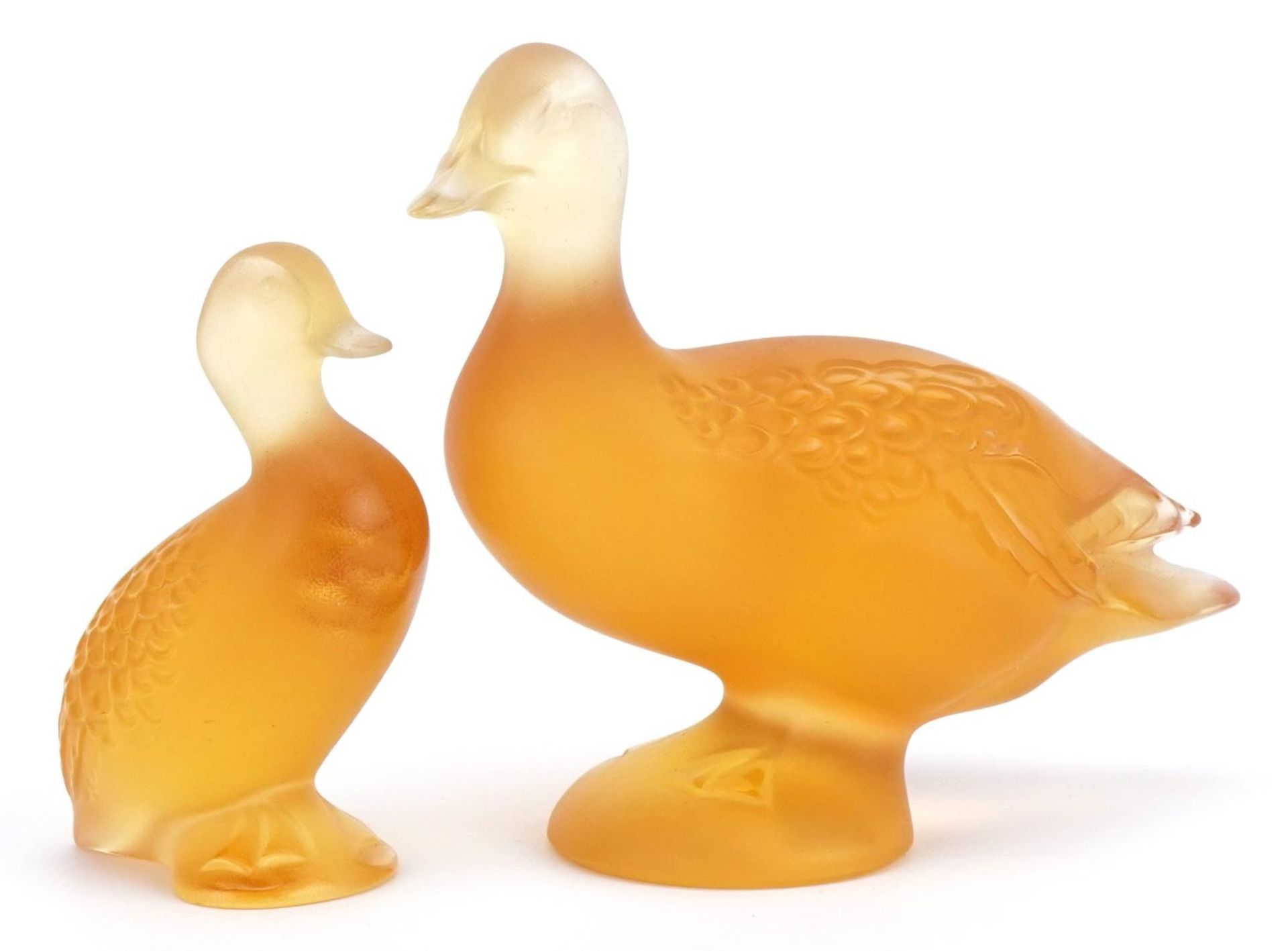 Lalique, two French frosted orange glass duck paperweights, one with paper label, each etched