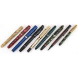 Six vintage fountain pens and propelling pencils, two with gold nibs including a red marbleised