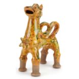 Turkish Canakkale pottery ewer having a yellow and green glaze, in the form of a lion, 20cm high :