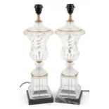Pair of French style glass urn table lamps with gilt metal mounts raised on faux marble bases,