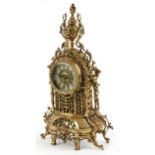 Gothic style ornate brass mantle clock with circular dial having Roman numerals, 49cm high : For