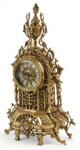 Gothic style ornate brass mantle clock with circular dial having Roman numerals, 49cm high : For