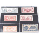 Antique and later world banknotes arranged in an album including China, Germany and Chile : For