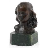 Patinated bronze head and shoulder bust of a young female raised on a green marbleised base, 15cm