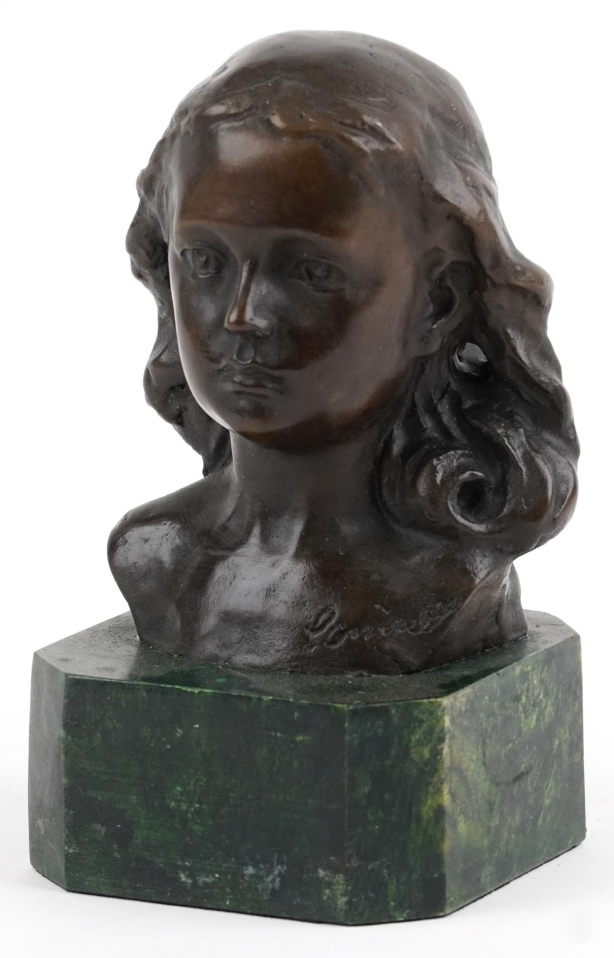 Patinated bronze head and shoulder bust of a young female raised on a green marbleised base, 15cm