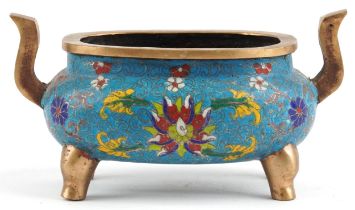 Chinese patinated bronze cloisonne four footed censer with twin handles enamelled with flower