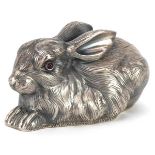 Silver recumbent rabbit with cabochon ruby eyes, impressed Russian marks to the base, 6.5cm in