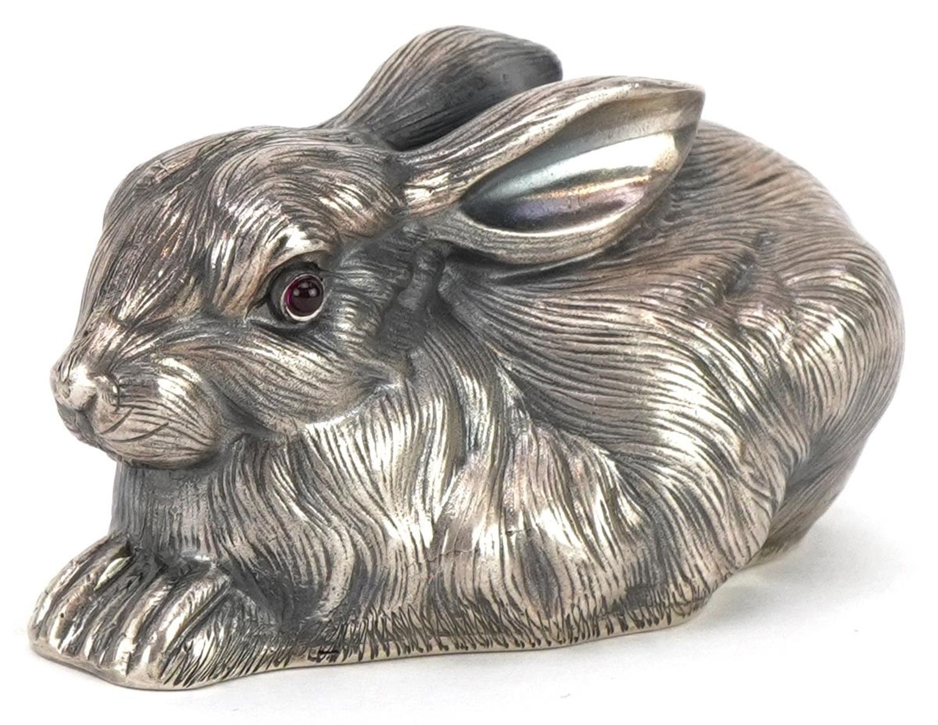 Silver recumbent rabbit with cabochon ruby eyes, impressed Russian marks to the base, 6.5cm in