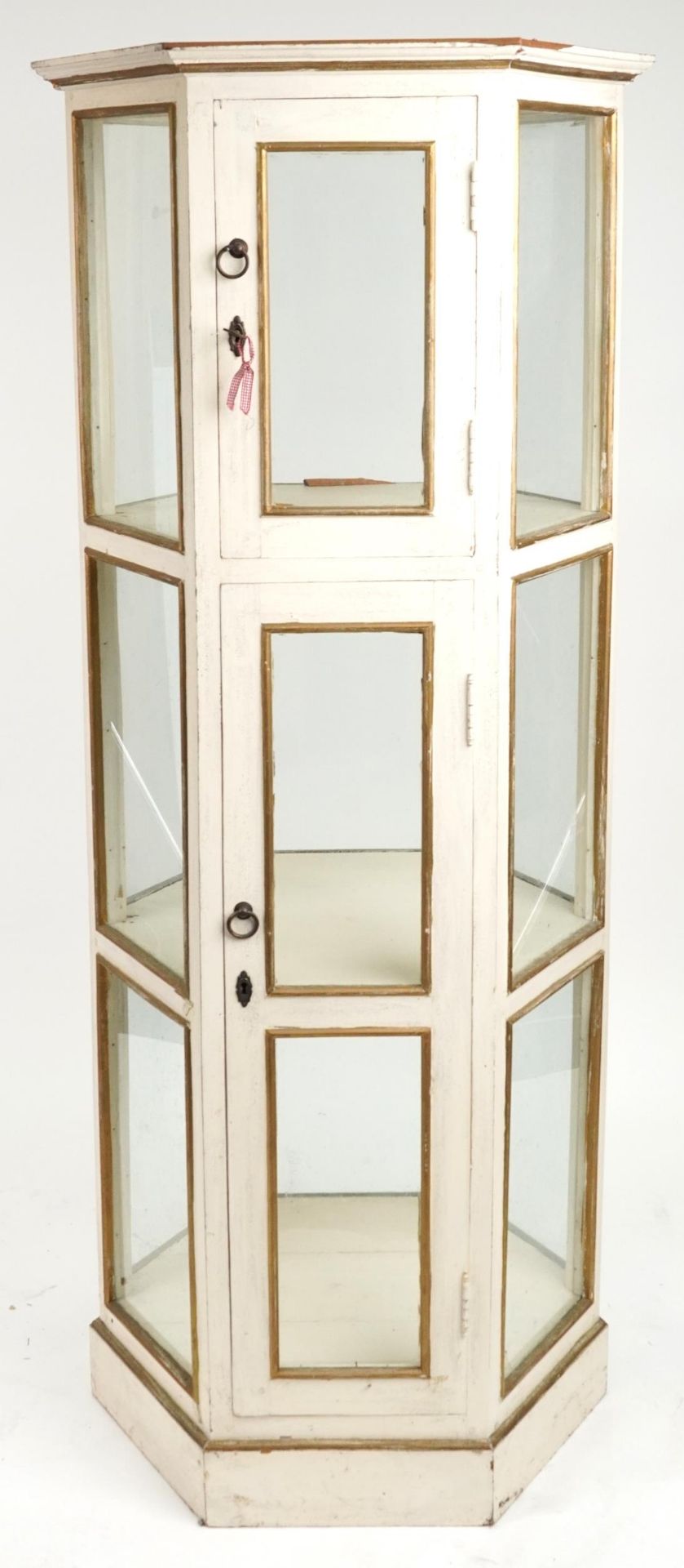 French style cream and gilt painted three tier hexagonal display cabinet with brass mounts, 180.
