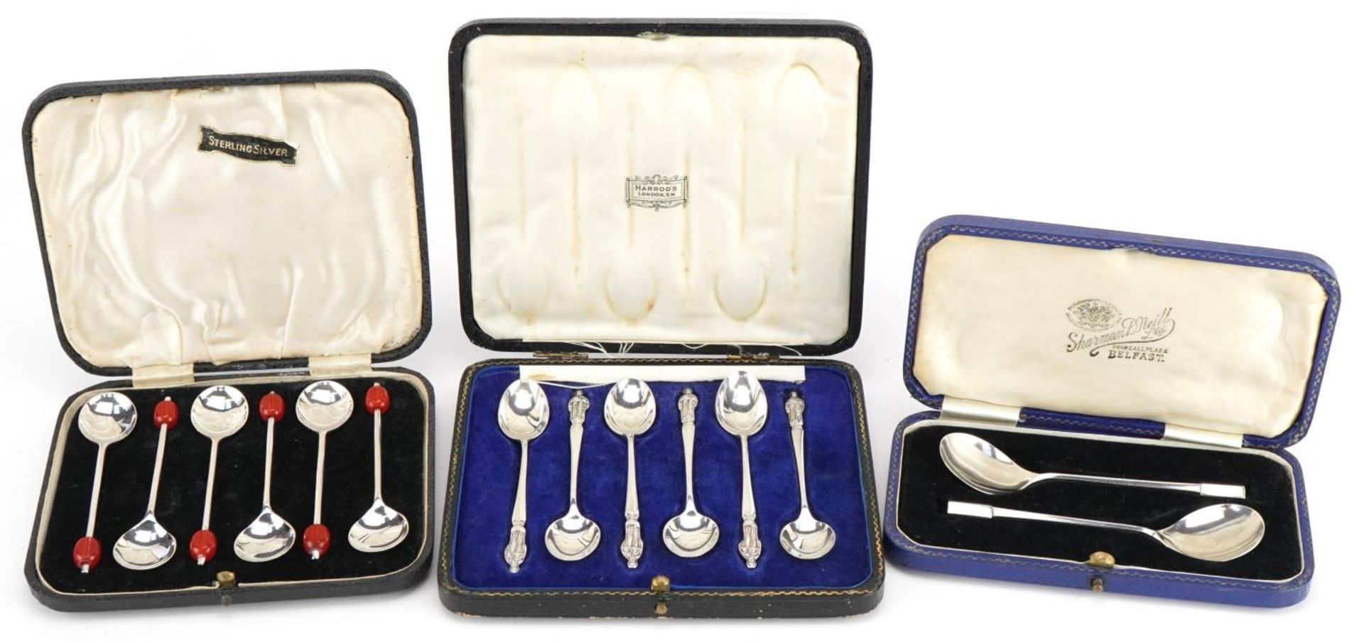 Three sets of silver spoons with cases comprising set of six apostle teaspoons housed in a Harrods