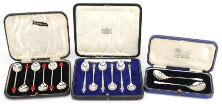 Three sets of silver spoons with cases comprising set of six apostle teaspoons housed in a Harrods