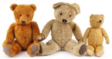 Three antique and later golden teddy bears with joined limbs including two straw filled examples,