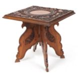 Anglo Indian hardwood folding side table, finely and deeply carved with an elephant and wild animals