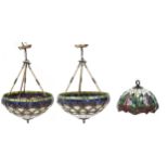 Three Art Nouveau style Tiffany design leaded light pendants including a pair, the pair each 44cm in