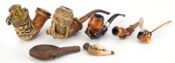 Six antique Meerschaum smoking pipes including three carved with hands, one carved with a wild