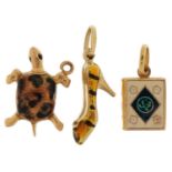 Three gold and enamel charms comprising 18ct gold Quran, 9ct gold high heeled shoe and unmarked gold