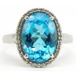 Large 9ct white gold blue topaz and diamond ring with pierced shoulders, the topaz approximately