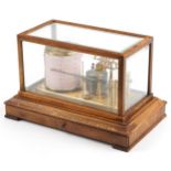 Committee of London barograph housed in a glazed oak case with bevelled glass and base drawer, 22.